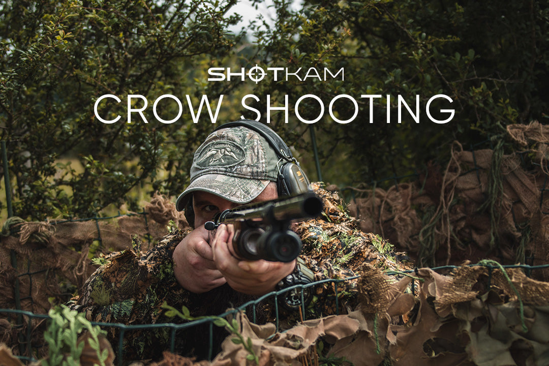 Hunter in full camouflage gear taking aim with a shotgun, highlighting ShotKam's crow shooting experience.