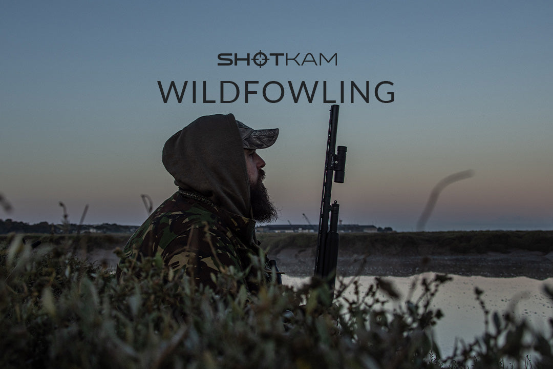 Canadian hunter at the water's edge during a morning wildfowling adventure, ready for duck hunting in the early light.