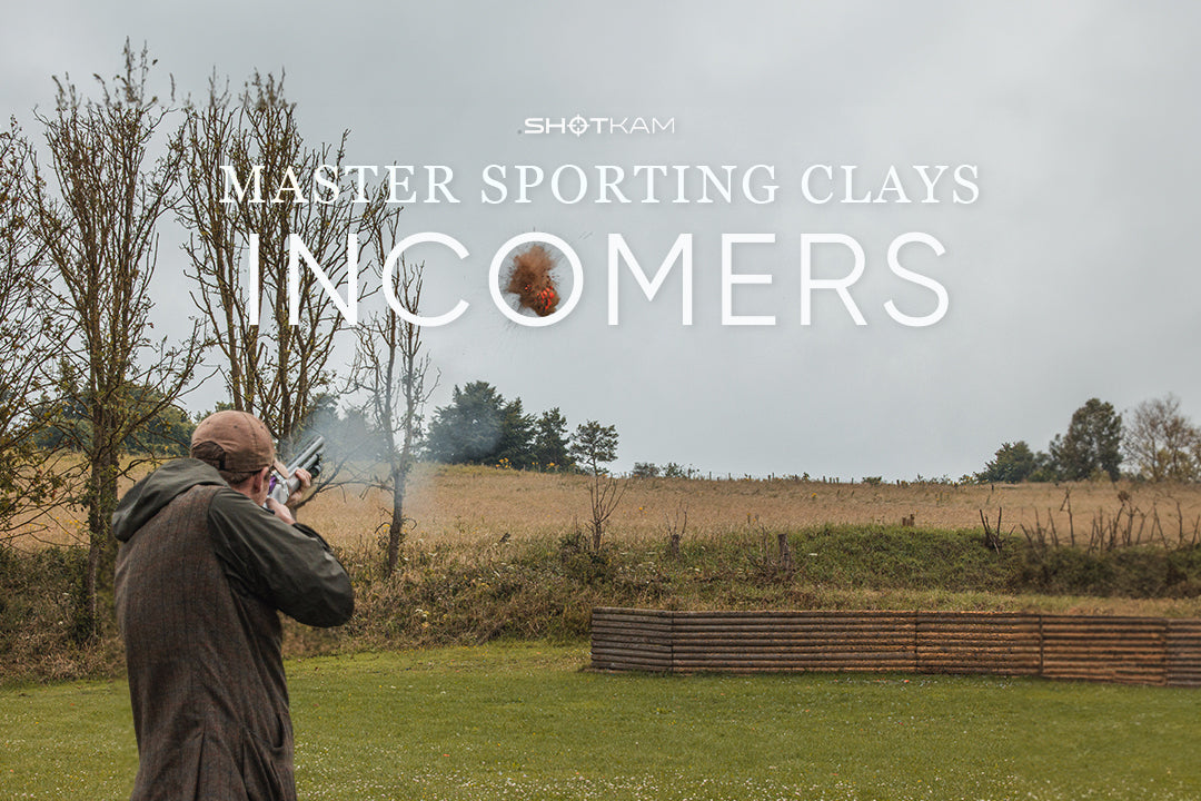 Close-up action shot of a clay target shattering mid-air as a shooter engages an incomer—ShotKam coaching insights on shooting technique.