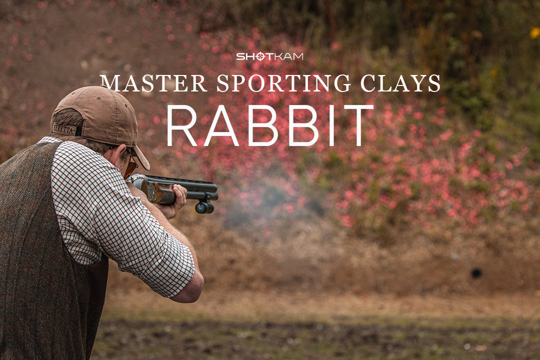Capturing the moment a shooter fires at a fast-moving rabbit target in a clay shooting match.