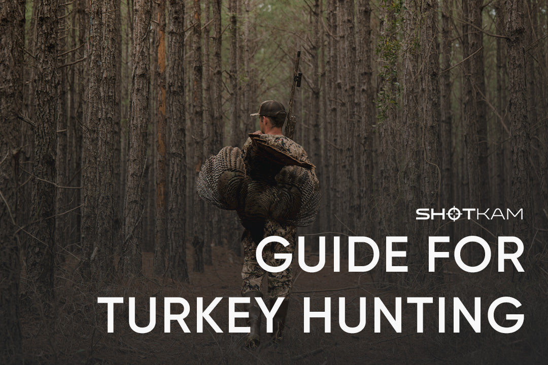 ShotKam mounted on shotgun capturing turkey hunting moment in forest with hunter carrying game