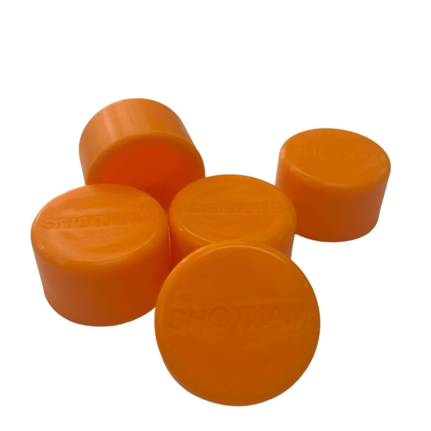 A set of five orange lens covers for ShotKam cameras, providing soft plastic protection for the lens.